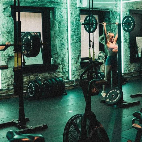 modern dynamic gym with stone walls and green lighting 