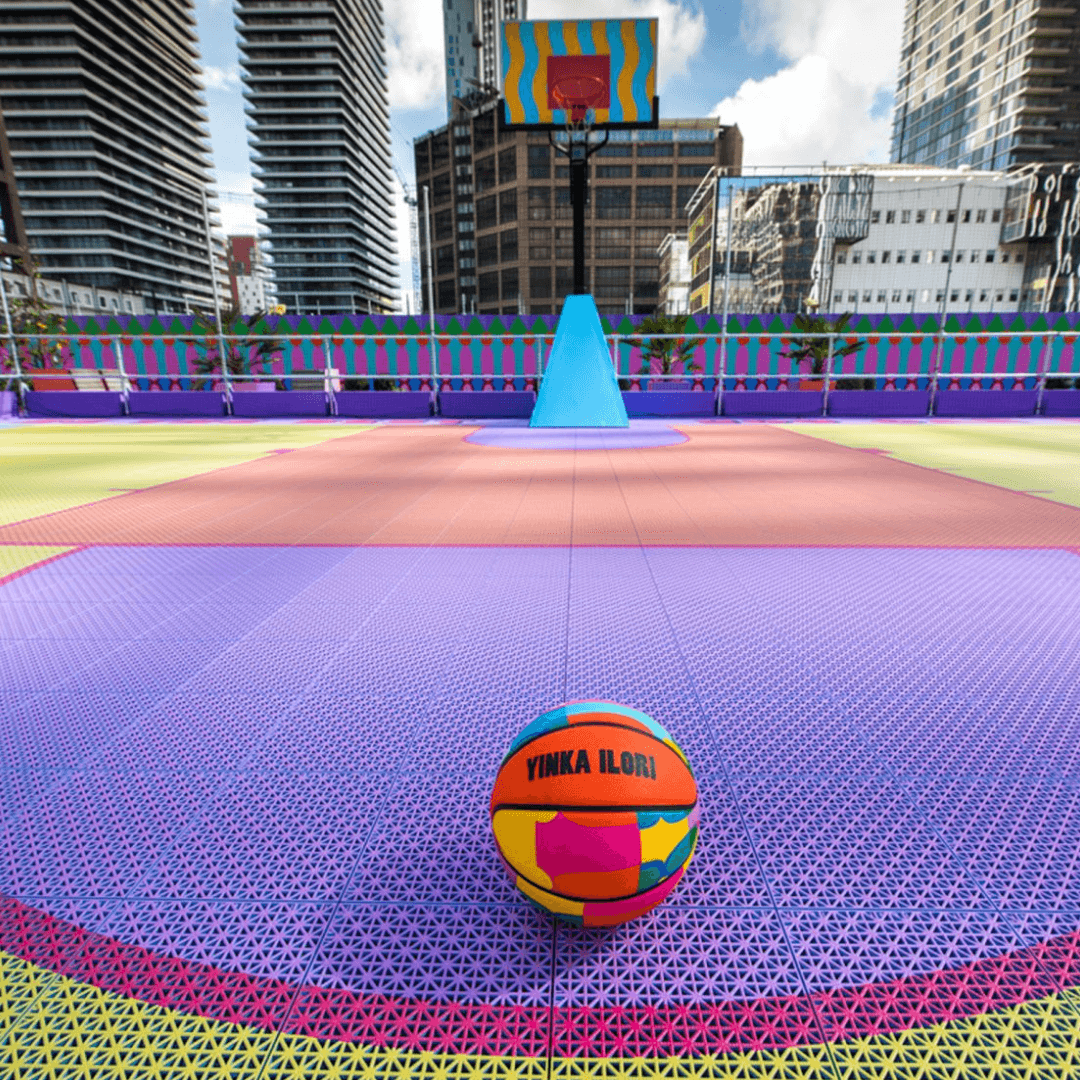 Bright coloured modular basketball tiles in an outdoor basketball court