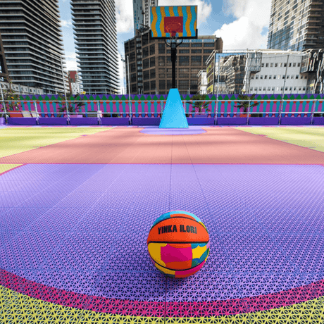 Bright coloured modular basketball tiles in an outdoor basketball court