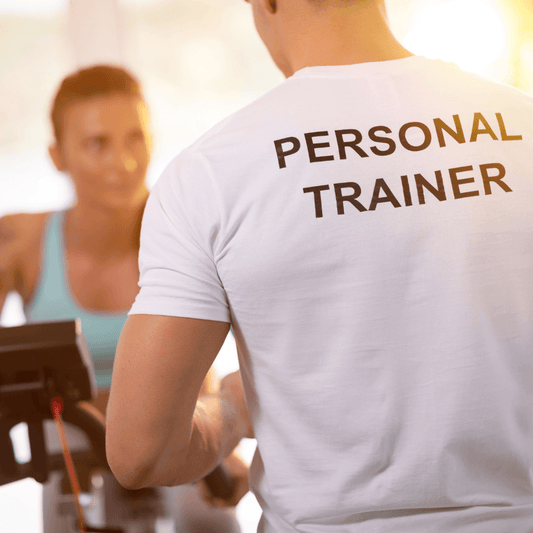 woman exercising with a male personal trainer