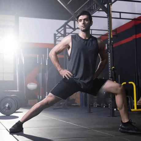 athletic man stretching in a gym