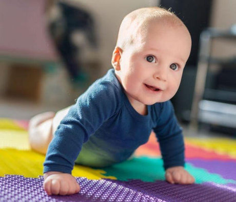 Baby on soft play matting