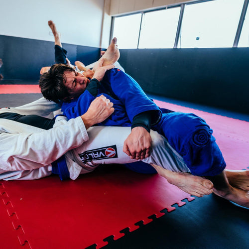 Men grappling on BJJ Tatami Mats